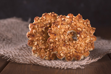 Round cookies with nuts on a wooden background