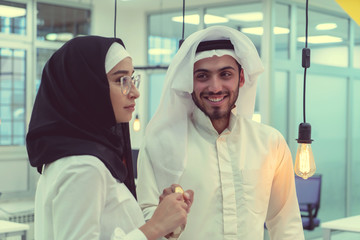 Young arabian muslim woman in hijab black clothes hold in hand holding bitcoin. Cryptocurrency exchange