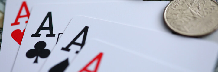 Playing cards lying at money stake with aces combination
