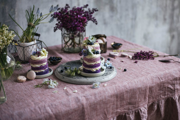 Purple cakes among spring flowers
