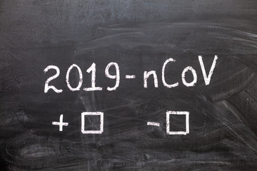 Obraz premium 2019-nCoV. The label and the boxes to tick on the chalk Board. Positive or negative. Coronavirus