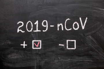 Obraz premium 2019-nCoV. The label and the boxes to tick on the chalk Board. Positive or negative. Coronavirus