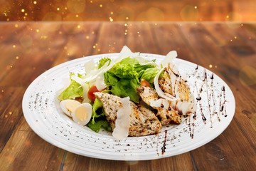 Fresh salad in white plate on wooden table