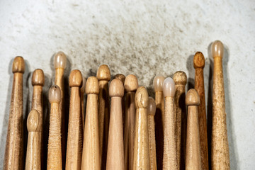Close-up of many wooden drumsticks on an old and dirty snare drum. Percussion instrument