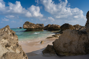 beautiful view on the lonely Fazayah Beach, Salalah Oman, Fantastic seascape, great outdoor scene of Beauty of nature concept background, blue sea, few clouds, light sandy beach, rocks in the water