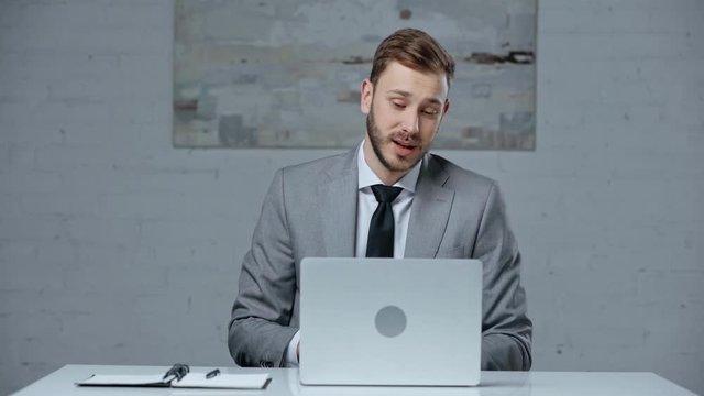 confident businessman having video call on laptop