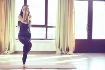 yoga balance girl / Yoga coach shows balance, yoga postures. Beautiful sporty graceful girl in the gym
