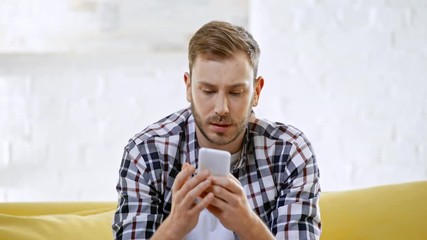 upset man making online bets on smartphone
