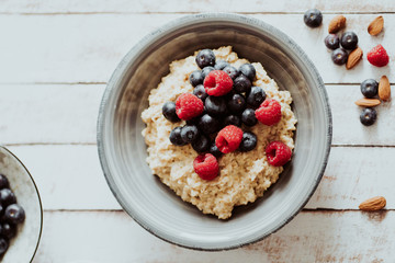Porridge bowl, oat meal with blueberries, raspberries and   almond splits