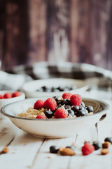 Porridge bowl, oat meal with blueberries, raspberries and   almond splits