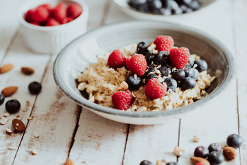 Porridge bowl, oat meal with blueberries, raspberries and   almond splits