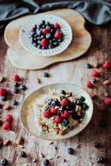 Obraz na płótnie Canvas Porridge bowl, oat meal with blueberries, raspberries and almond splits