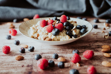 Porridge bowl, oat meal with blueberries, raspberries and   almond splits
