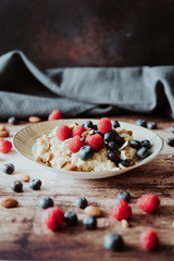 Porridge bowl, oat meal with blueberries, raspberries and   almond splits