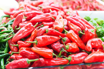 Display of locally grown red bell peppers for sale at local farmers market