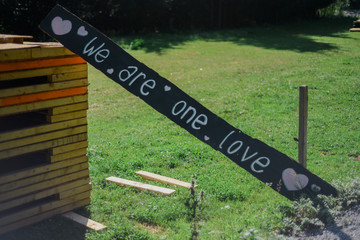 "We are one love" written on a sign in the countryside