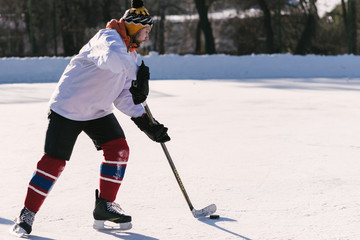 Fototapeta premium the man plays hockey on the rink