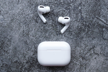 Wireless headphones on a grey factor background