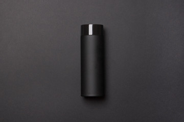 black thermos cup on black background