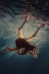 The girl actively swims underwater