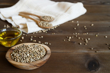 Fototapeta na wymiar hemp seeds on a wooden background as a healthy food concept