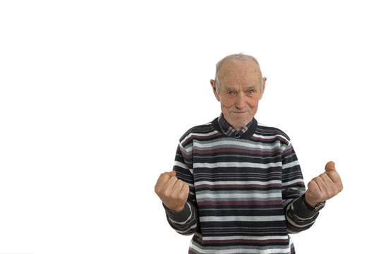 Waist Up Portrait Of The Old Man In Casual Clothes, Senior Is Very Happy And Excited Doing Winner Gesture With Arms Raise, Looking At The Camera, Isolated Over White Background. Celebration Concept