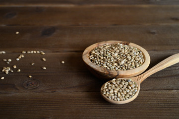 hemp seeds on a wooden background as a healthy food concept