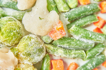 frozen brussels sprouts and broccoli cabbage green beans asparagus and carrots. macro. texture. close-up