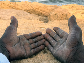 Hands of an immigrant showing the suffering of people seeking a dignified life for themselves and...