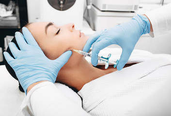 woman having facial injections for facelift and anti-aging effect