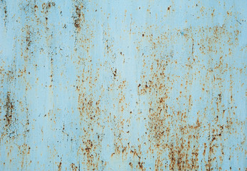 Old faded light blue metal with peeling paint, small spots of rust and scratches. Abstract background, texture.