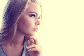 young adult blonde long hair at home, stylish model posing in the studio