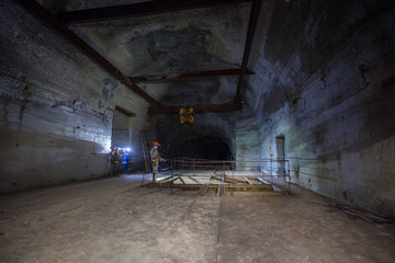 Fototapeta na wymiar Underground gold mine tunnel with unfinished ore crusher room