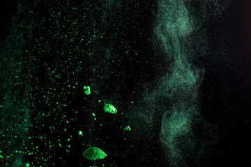 green colorful holi paint explosion on black background