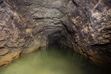 Underground gold ore mine tunnel drowned water