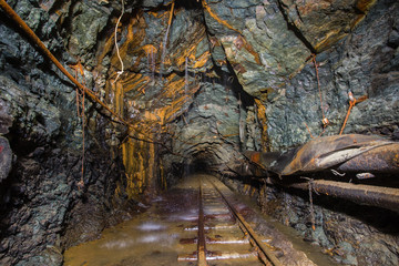 Fototapeta na wymiar Old gold mine underground tunnel with rails
