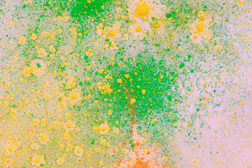 Obraz na płótnie Canvas orange, yellow and green colorful holi paint explosion