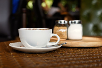 hot cup of coffee on the wood table.