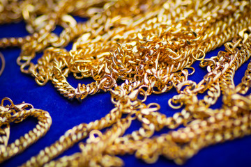 Gold bracelet on blue background