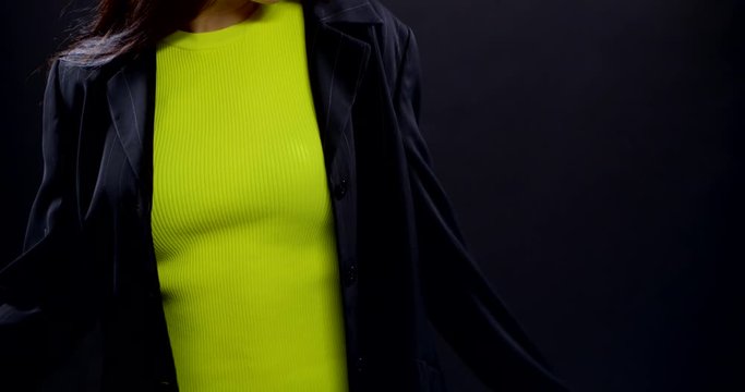 girl with long hair dances on black background in studio
