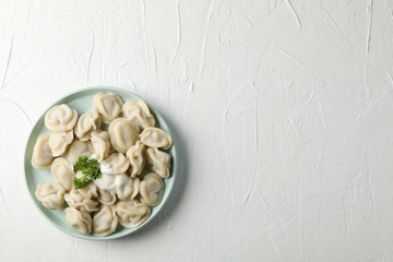 Plate with dumplings on white background, close up