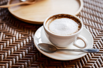 hot cup of coffee on the wood table in the morning.