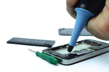 Phone cleaning and repairs into the motherboard for smartphone By professional technician on desk.