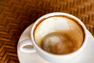 Empty coffee cup after drink on wood table.
