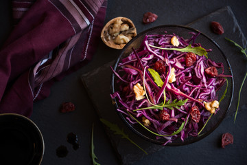 Red cabbage salad with nuts and arugola