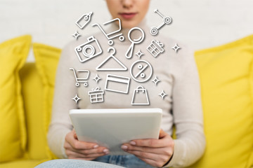 Cropped view of girl using digital tablet near illustration