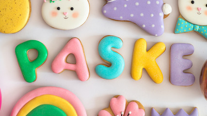 Happy Easter. Multicolored pastel easter cookies on a white background.