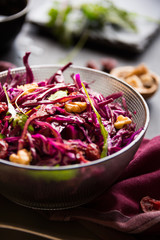 Red cabbage salad with nuts and arugola