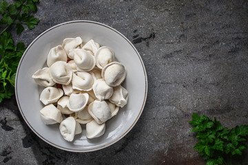 tortellini with filling (ravioli dumplings) menu concept. food background. top view. copy space