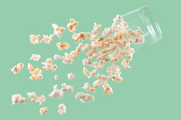 Delicious looking popcorn falling from a glass